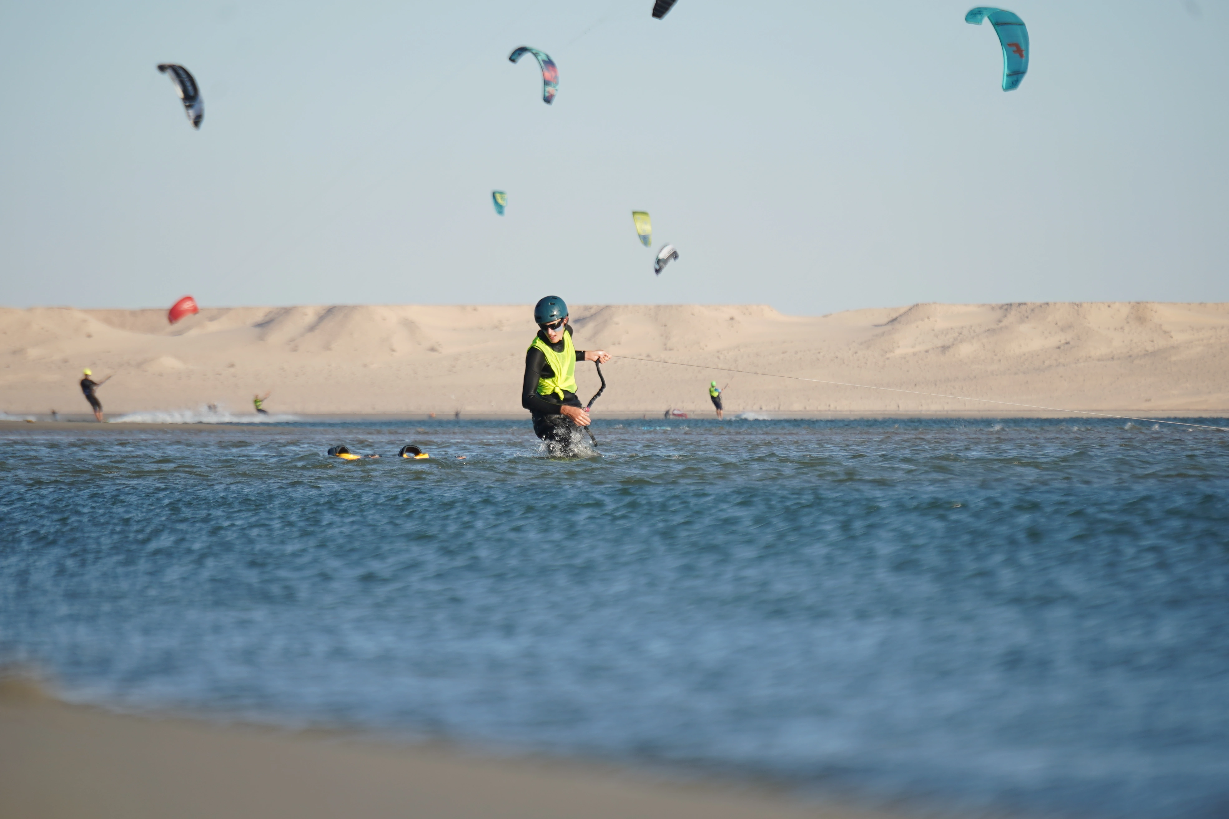 A kitesurfer training at high speed on the perfectly flat water of the Dakhla Speed Spot during a Bluboarding excursion.