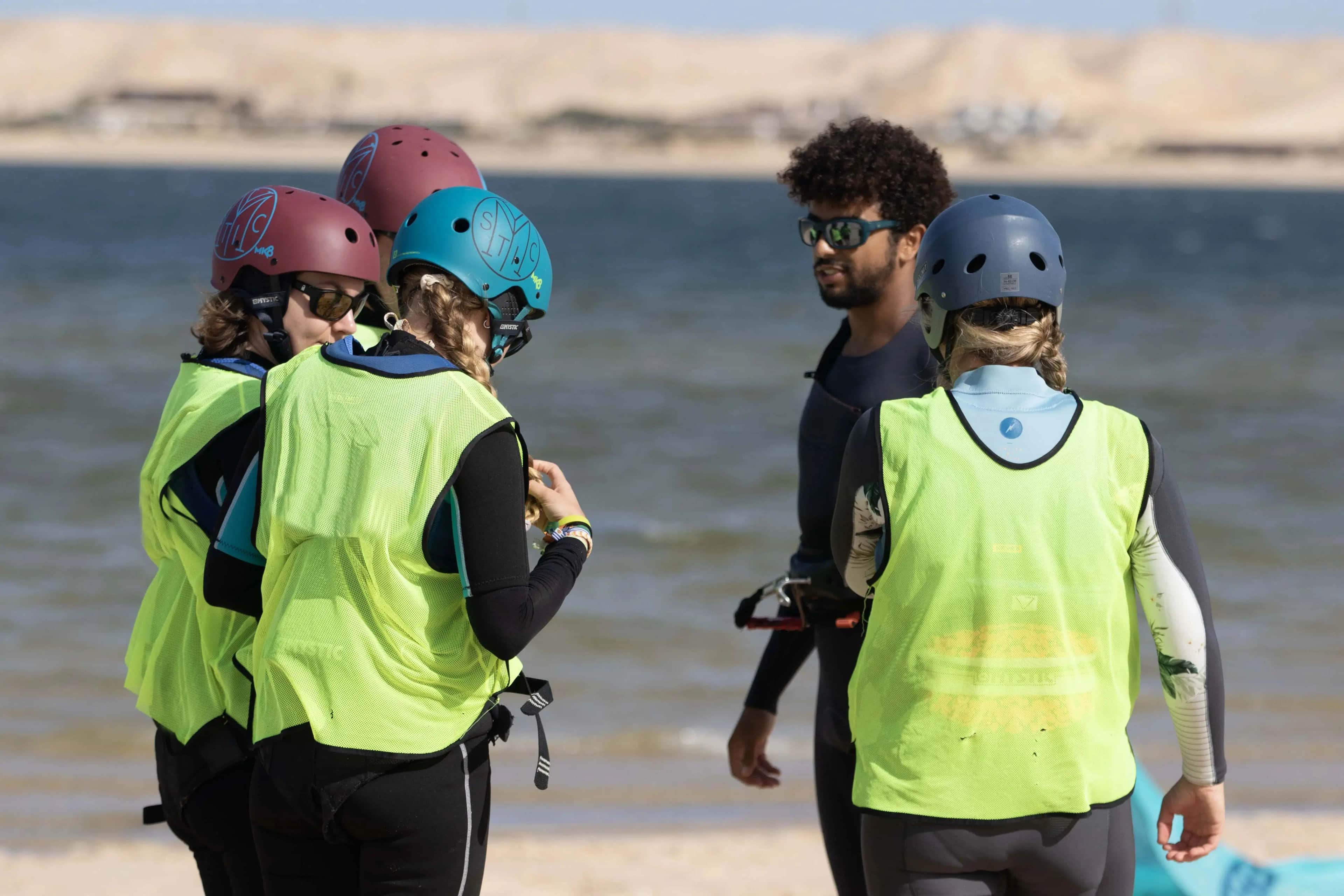 A group of new friends learning to kitesurf together in a fun lesson with Bluboarding.