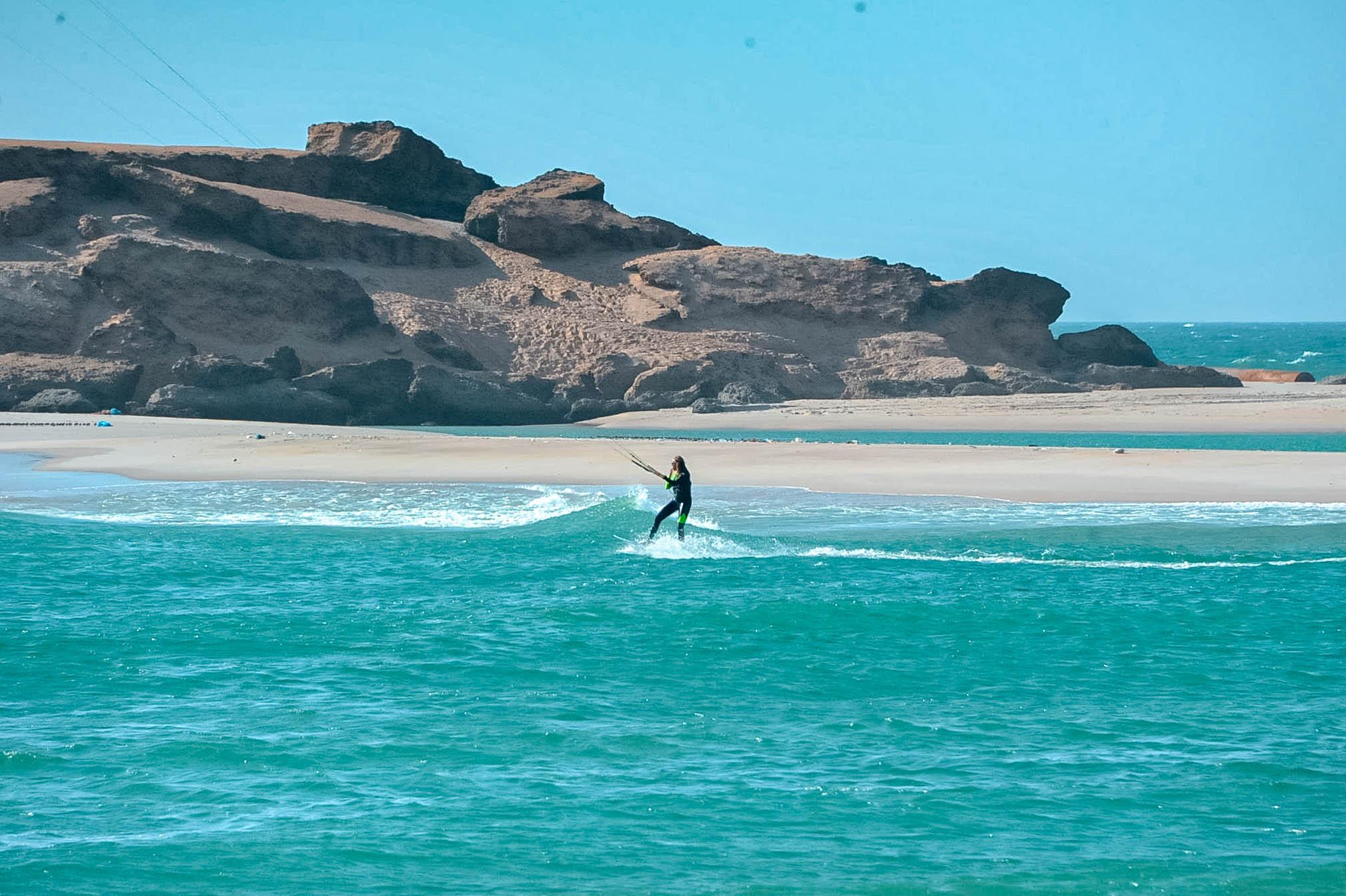 Bluboarding client paddling toward the peak to catch a wave at Point d'Or, the Atlantic ocean break near Dakhla.