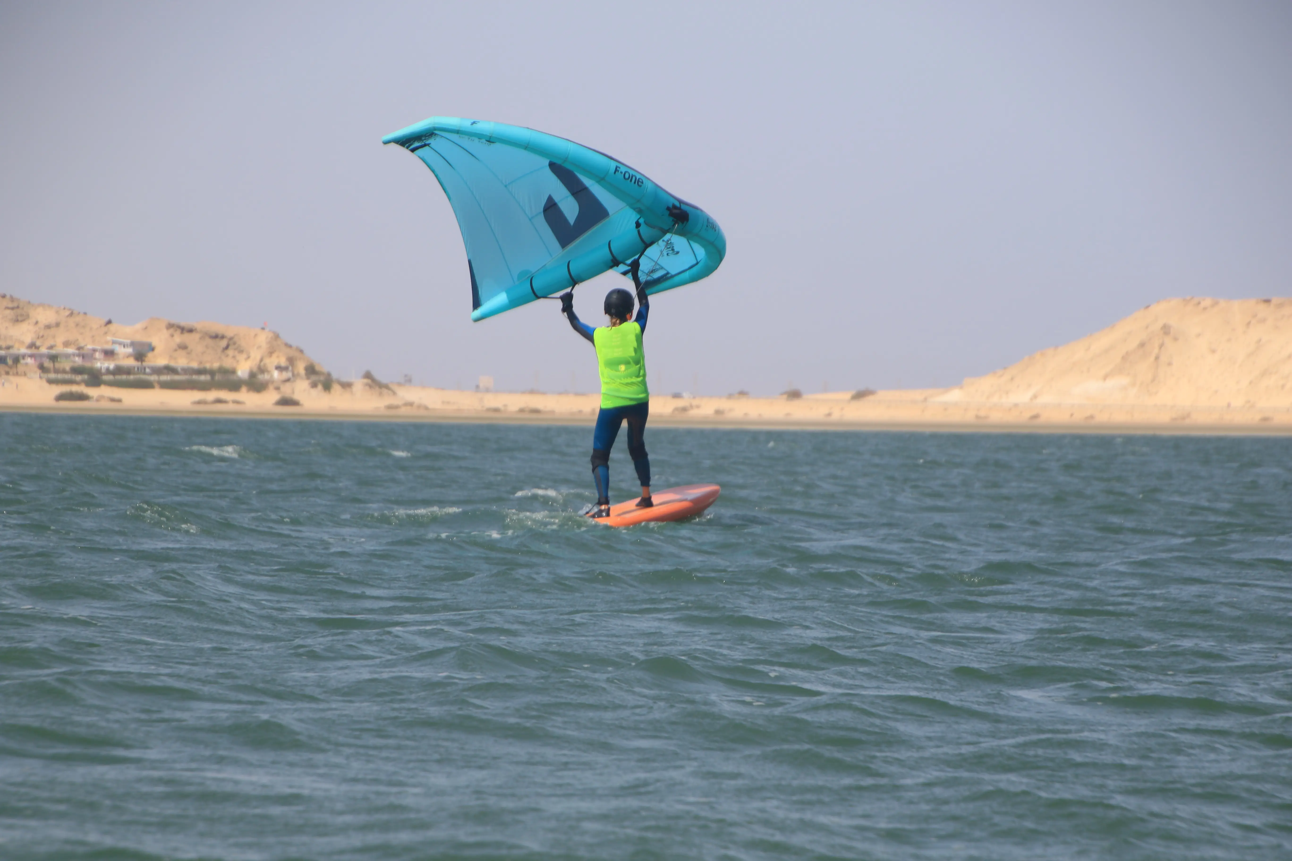 wingfoil-beginner-on-the-board-taking-off