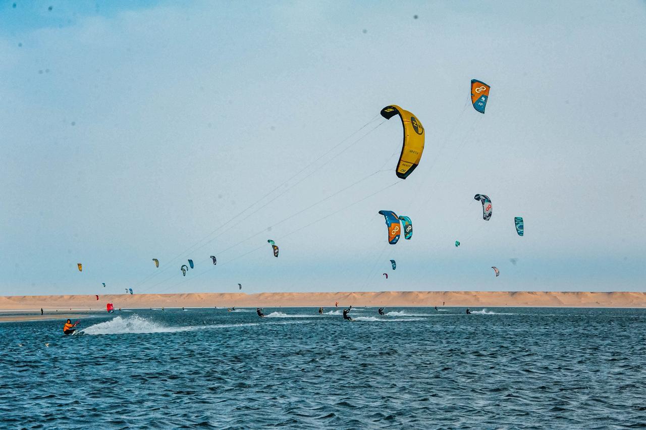 Bluboarding clients kitesurfing on a sunny day at Speed Spot on the Dakhla lagoon with consistent wind conditions in Morocco.